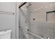Shower with gray tile, glass enclosure, and brushed nickel fixtures at 14312 Barbarossa Ln, Port Charlotte, FL 33981