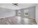 Spacious bedroom with gray walls, vinyl plank flooring, and two windows at 14312 Barbarossa Ln, Port Charlotte, FL 33981
