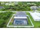 Aerial view of a house with a pool and fenced backyard at 14312 Barbarossa Ln, Port Charlotte, FL 33981