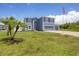 Two-story house with a two-car garage and landscaped lawn at 14312 Barbarossa Ln, Port Charlotte, FL 33981