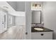 Modern powder room with dark countertop, white vanity, and elegant mirror at 14312 Barbarossa Ln, Port Charlotte, FL 33981