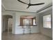 Open living room with breakfast bar and ceiling fan at 6414 Moorings Point Cir # 201, Lakewood Ranch, FL 34202