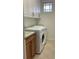 Bright laundry room with washer, dryer and cabinets at 6414 Moorings Point Cir # 201, Lakewood Ranch, FL 34202