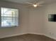 Bedroom with hardwood floors, ceiling fan, and large window at 6414 Moorings Point Cir # 201, Lakewood Ranch, FL 34202