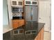 Island kitchen with granite countertops and stainless steel appliances at 6414 Moorings Point Cir # 201, Lakewood Ranch, FL 34202