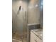 Modern shower with glass enclosure and mosaic tile flooring at 6414 Moorings Point Cir # 201, Lakewood Ranch, FL 34202