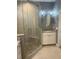 Large bathroom with a corner shower, granite vanity, and modern fixtures at 6414 Moorings Point Cir # 201, Lakewood Ranch, FL 34202