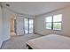 Bright bedroom featuring sliding glass doors to a private balcony at 5707 N Honore Ave # 621, Sarasota, FL 34243