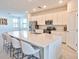 Modern kitchen with white cabinets and large island at 5707 N Honore Ave # 621, Sarasota, FL 34243