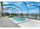 Sparkling pool and jacuzzi inside screened lanai, overlooking the lake view at 12918 Rainwashed Loop, Parrish, FL 34219