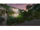 Two-story home with evening lighting and lush landscaping at 1485 Landings Lake Dr # 36, Sarasota, FL 34231