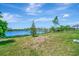 Grass backyard with lake view and community background at 19765 Fishhawk Trl, Venice, FL 34293