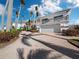 Two-story home with large garage and palm trees at 596 Yawl Ln, Longboat Key, FL 34228