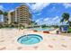 Resort-style pool and spa with lounge chairs at 3080 Grand Bay Blvd # 532, Longboat Key, FL 34228