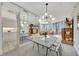 Bright dining area with glass table and modern chandelier, reflecting in large mirrors at 3080 Grand Bay Blvd # 532, Longboat Key, FL 34228