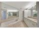 Spa-like bathroom with double vanity, large mirror, and jetted tub at 3080 Grand Bay Blvd # 532, Longboat Key, FL 34228