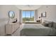 Guest bedroom with two twin beds, dresser, and scenic view at 3080 Grand Bay Blvd # 532, Longboat Key, FL 34228
