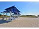 Beachfront property with shaded cabanas and picnic tables at 3080 Grand Bay Blvd # 532, Longboat Key, FL 34228