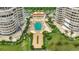 Aerial view of community pool, building, and landscaping at 3080 Grand Bay Blvd # 532, Longboat Key, FL 34228