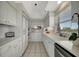 White kitchen with stainless steel appliances and white cabinetry at 3080 Grand Bay Blvd # 532, Longboat Key, FL 34228