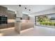 Modern kitchen with island, marble counters, and sliding doors to patio at 214 S Renellie Dr, Tampa, FL 33609