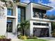 Modern two-story home with a two-car garage and landscaped yard at 214 S Renellie Dr, Tampa, FL 33609