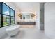 Spa-like bathroom with a freestanding tub and marble finishes at 214 S Renellie Dr, Tampa, FL 33609