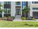 Modern home entrance with landscaping and a two-car garage at 214 S Renellie Dr, Tampa, FL 33609