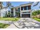 Modern two-story home with a two-car garage and landscaped yard at 214 S Renellie Dr, Tampa, FL 33609