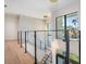 Modern staircase with glass railings and light wood flooring at 214 S Renellie Dr, Tampa, FL 33609