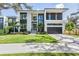 Modern two-story home with a two-car garage and landscaped yard at 214 S Renellie Dr, Tampa, FL 33609