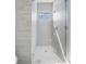 Spa-like shower with frameless glass enclosure and a window at 214 S Renellie Dr, Tampa, FL 33609