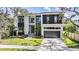 Modern two-story home with a two-car garage and landscaped yard at 214 S Renellie Dr, Tampa, FL 33609