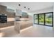 Modern kitchen with island, marble counters, and sliding doors to patio at 214 S Renellie Dr, Tampa, FL 33609