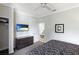 King bed, mounted TV, and view into living room at 1020 Sun N Sea Dr # 102, Sarasota, FL 34242
