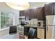 Small kitchen with stainless steel appliances and dining table at 1020 Sun N Sea Dr # 102, Sarasota, FL 34242