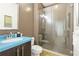Modern bathroom with walk-in shower and blue vanity at 1020 Sun N Sea Dr # 102, Sarasota, FL 34242