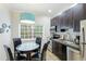 Modern kitchen with stainless steel appliances and breakfast bar at 1020 Sun N Sea Dr # 102, Sarasota, FL 34242