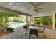 Covered patio with grills and seating area at 1020 Sun N Sea Dr # 102, Sarasota, FL 34242