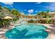 Community pool with building view and lounge chairs at 1020 Sun N Sea Dr # 102, Sarasota, FL 34242