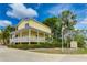 Inviting yellow building with a porch and landscaping; The Beach Club sign is visible at 1020 Sun N Sea Dr # 102, Sarasota, FL 34242