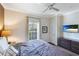 King bed, window with balcony access and mounted TV at 1020 Sun N Sea Dr # 102, Sarasota, FL 34242