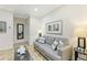 Living area with sofa, coffee table, and large mirror at 1020 Sun N Sea Dr # 102, Sarasota, FL 34242