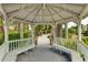 Relaxing gazebo with benches overlooking gardens at 1020 Sun N Sea Dr # 102, Sarasota, FL 34242