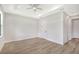 Bright bedroom with wood-look tile floors and access to bathroom at 4476 Skyway Ave, North Port, FL 34288