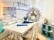 Bright dining area with a farmhouse table and beach-themed decor at 8630 Midnight Pass Rd # 103A, Sarasota, FL 34242