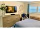 Bedroom with dresser and bed, featuring coastal decor at 8630 Midnight Pass Rd # 103A, Sarasota, FL 34242