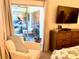 Bedroom with sliding doors to patio and comfy chair at 8630 Midnight Pass Rd # 103A, Sarasota, FL 34242
