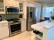 Modern kitchen with stainless steel appliances and white cabinets at 8630 Midnight Pass Rd # 103A, Sarasota, FL 34242