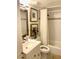 Bathroom with tub, toilet and updated vanity at 8630 Midnight Pass Rd # 103A, Sarasota, FL 34242